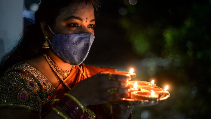 [Celebrating Diwali wearing a mask]